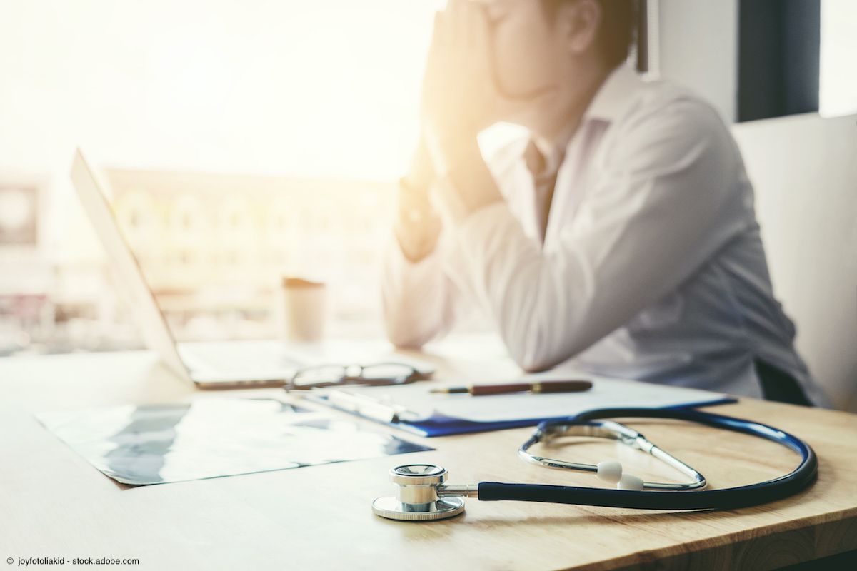 Stethoscope and doctor sitting with laptop stress headache about work in hospital | Image Credit: ©  joyfotoliakid - stock.adobe.com 