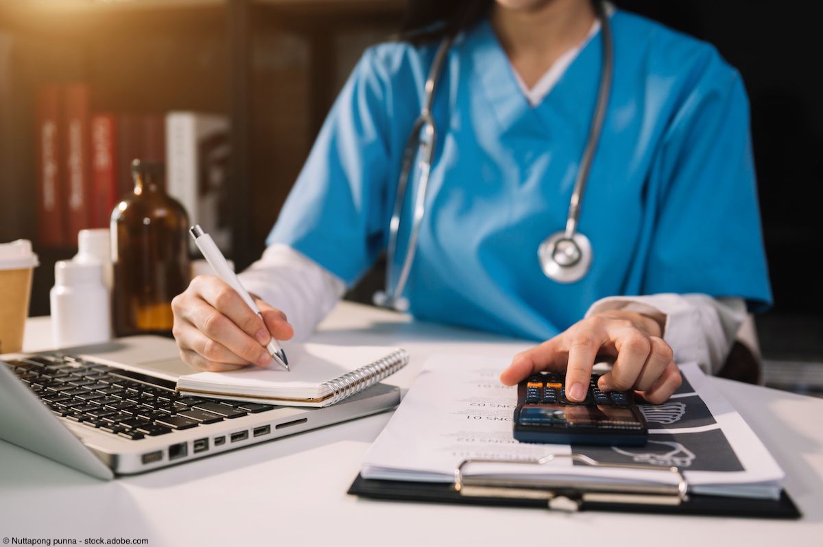 Hand of smart doctor used a calculator and smartphone, tablet for medical costs at hospital in morning light | Image Credit: © Nuttapong punna - stock.adobe.com