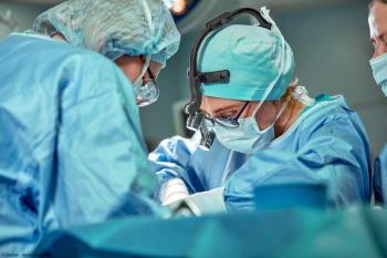 Group of surgeons looking at patient on operation table during their work | Image Credit: © Georgii - stock.adobe.com