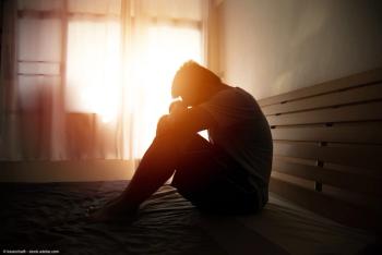 Depressed man sitting on bed | Image Credit: © kwanchaift - stock.adobe.com