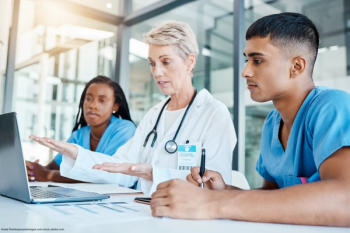 mentor teaching two medical students