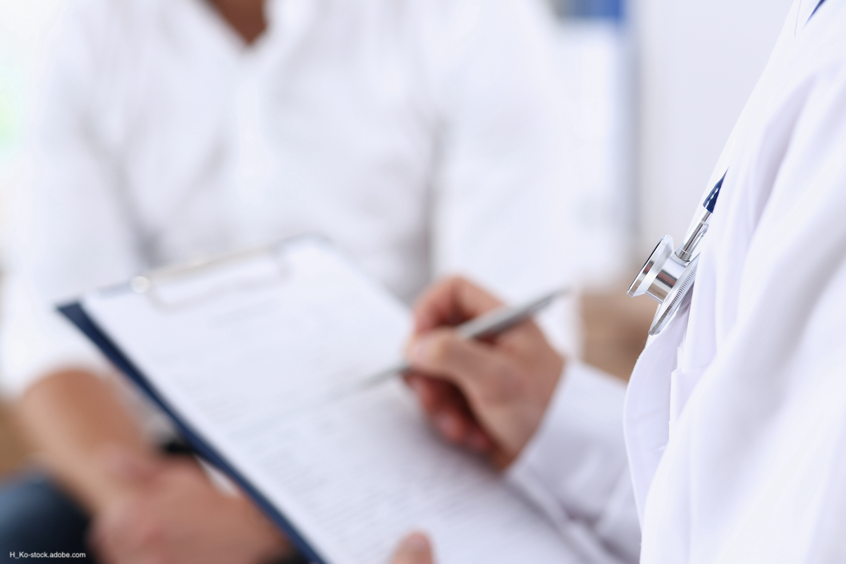 zoomed in photo of a doctor writing on a clipboard