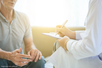 doctor writing on clipboard while talking to a male patient