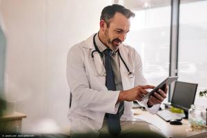 Doctor using digital tablet in his clinic | Image Credit: © Jacob Lund - stock.adobe.com