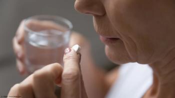 Close-up of elderly woman about to take aspirin | Image Credit: © fizkes - stock.adobe.com