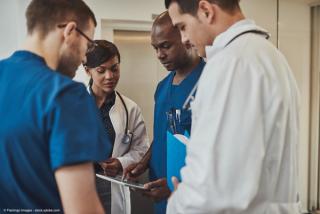 Diverse doctors having a conversation | Image Credit: © Flamingo Images - stock.adobe.com