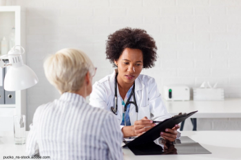Woman speaking with her female doctor