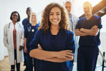 young female doctor standing in front of medical staff