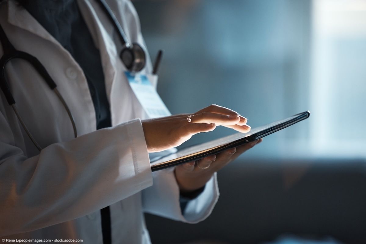 Telehealth, digital tablet and doctor hands for hospital innovation, software management and results update in dark workplace. Healthcare, cardiology and telecom medical professional with technology | Image Credit: © Rene L/peopleimages.com - stock.adobe.com