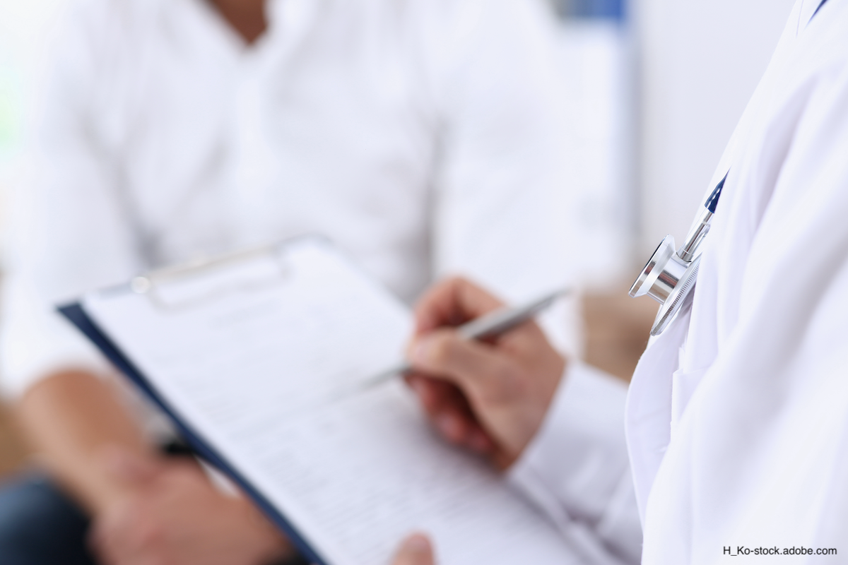 Doctor writing on a blurred clipboard