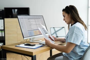 Woman doctor doing medical billing at computer | Image Credit: © Andrey Popov - stock.adobe.com