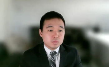 Perry Xu, MD, answers a question during a Zoom video interview