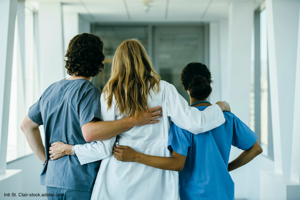 backs of 3 doctors hugging