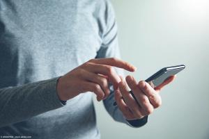 Man holding smartphone | Image Credit: © ARAMYAN - stock.adobe.com