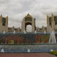 Ornate entrance gate of Ramoji Film City with fountains and mosaic 'Movie Magic' lettering under a cloudy sky.