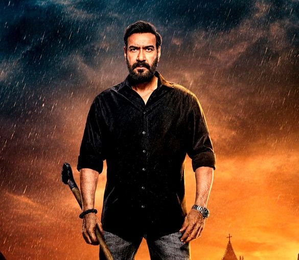 Bearded man in a black shirt holding a tool at his side, standing in rain under a dark, stormy orange sky