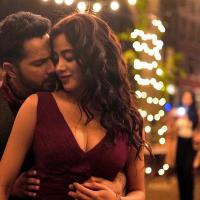 Varun Dhawan and Janhvi Kapoor in a still from Bawaal, on a street hung with string lights at night