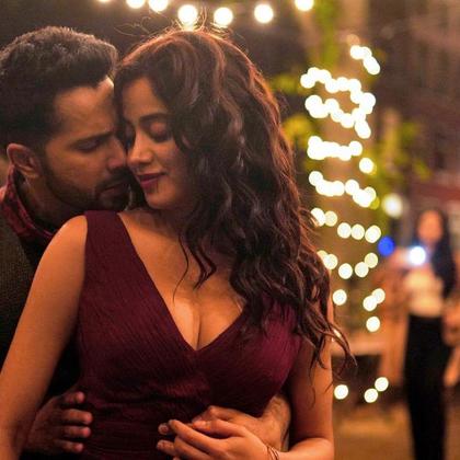 Varun Dhawan and Janhvi Kapoor in a still from Bawaal, on a street hung with string lights at night