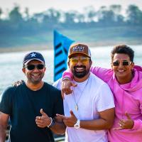 Rannvijay Singha in a cap and white T-shirt with Prince Narula in a pink hoodie and photographer Ashish Parmar, beside a lake