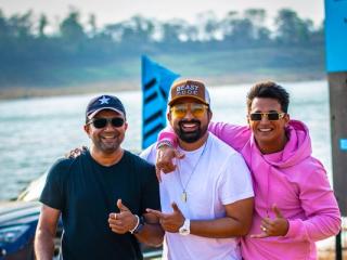 Rannvijay Singha in a cap and white T-shirt with Prince Narula in a pink hoodie and photographer Ashish Parmar, beside a lake