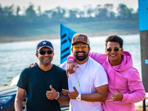 Rannvijay Singha in a cap and white T-shirt with Prince Narula in a pink hoodie and photographer Ashish Parmar, beside a lake