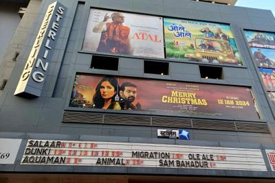 Cinema front with a vertical Sterling sign, film posters, a showtimes board and a box office sign