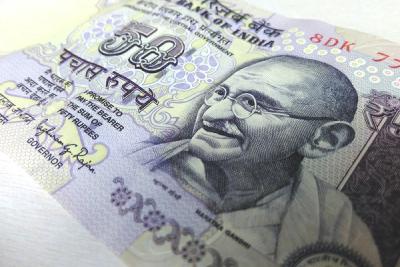 Close-up of a 50-rupee Indian banknote lying at an angle on a light surface