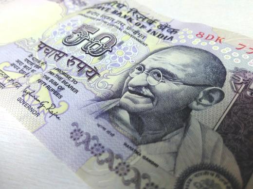 Close-up of a 50-rupee Indian banknote lying at an angle on a light surface