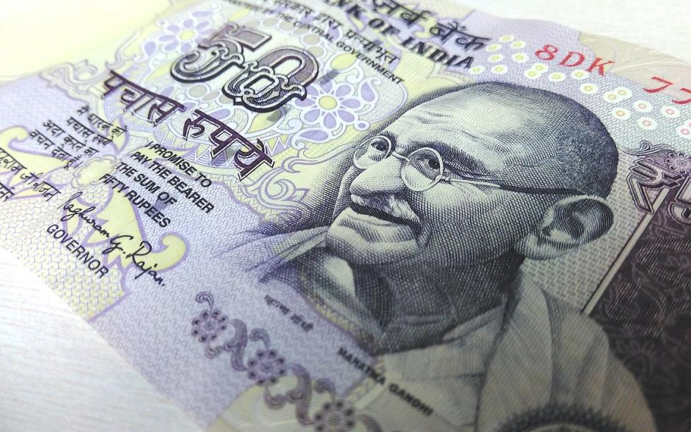 Close-up of a 50-rupee Indian banknote lying at an angle on a light surface