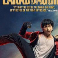 Film poster of a young man mid-kick on the roof of a yellow taxi, with a dog behind him and a red-and-grey title