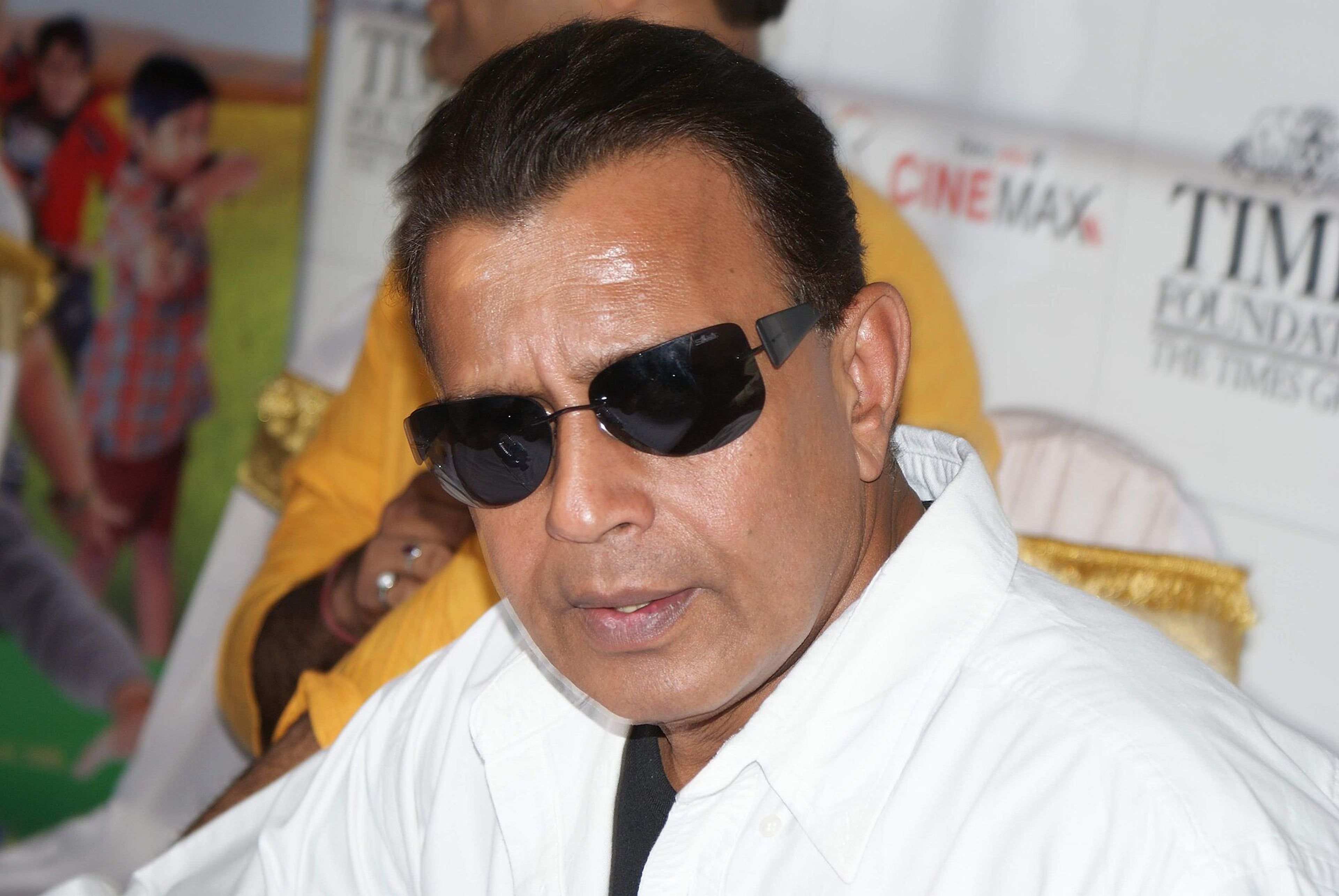 Mithun Chakraborty in sunglasses and a white shirt at an event in Mumbai