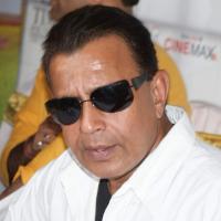 Mithun Chakraborty in sunglasses and a white shirt at an event in Mumbai