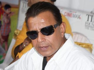 Mithun Chakraborty in sunglasses and a white shirt at an event in Mumbai