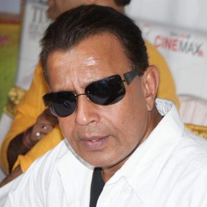 Mithun Chakraborty in sunglasses and a white shirt at an event in Mumbai