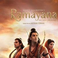 Official poster for Ramayana showing three figures in saffron costumes against a rocky landscape at sunset