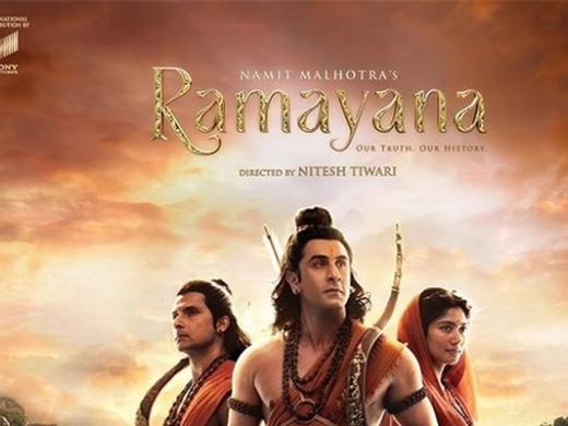 Official poster for Ramayana showing three figures in saffron costumes against a rocky landscape at sunset