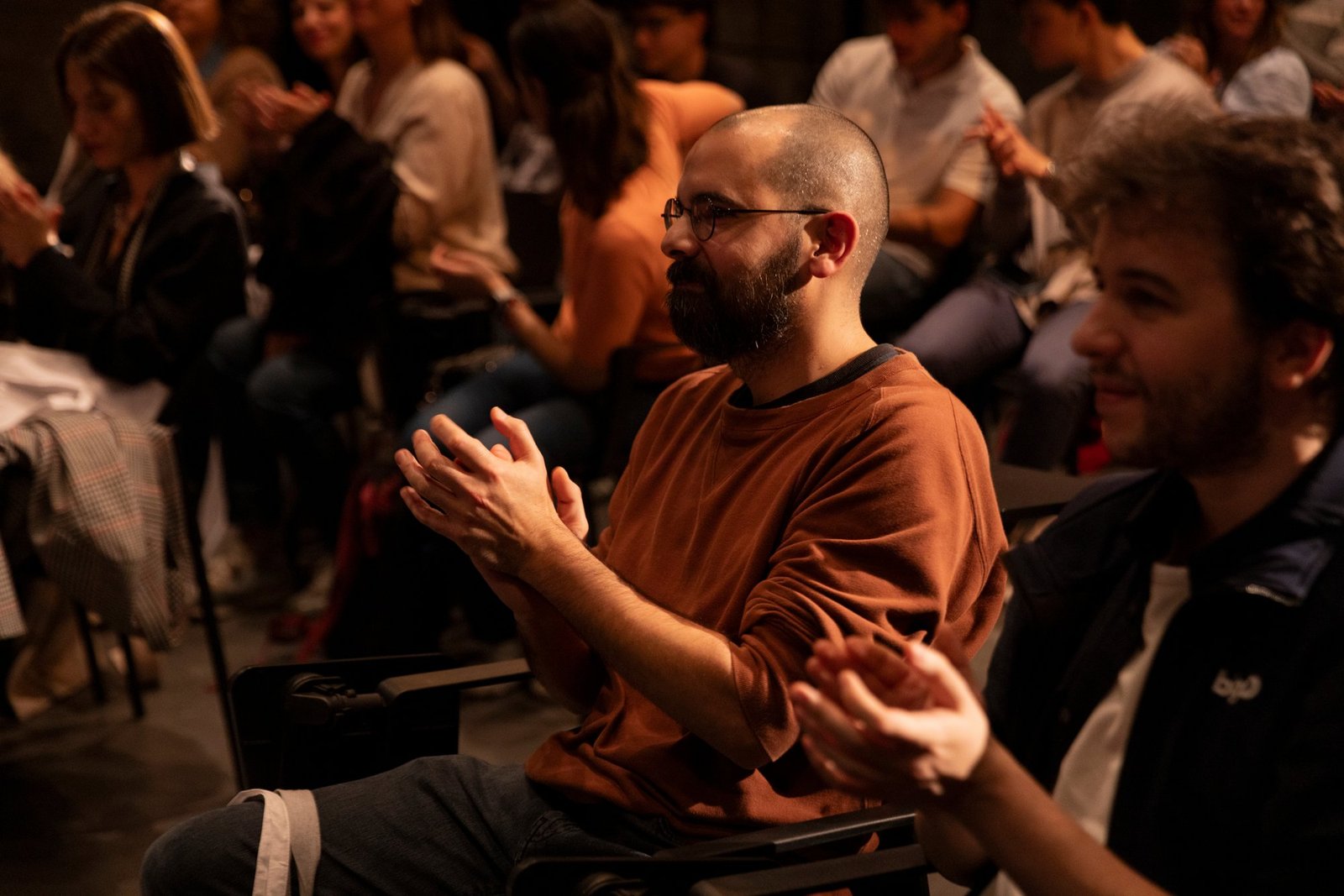 Seated attendees applauding during a session