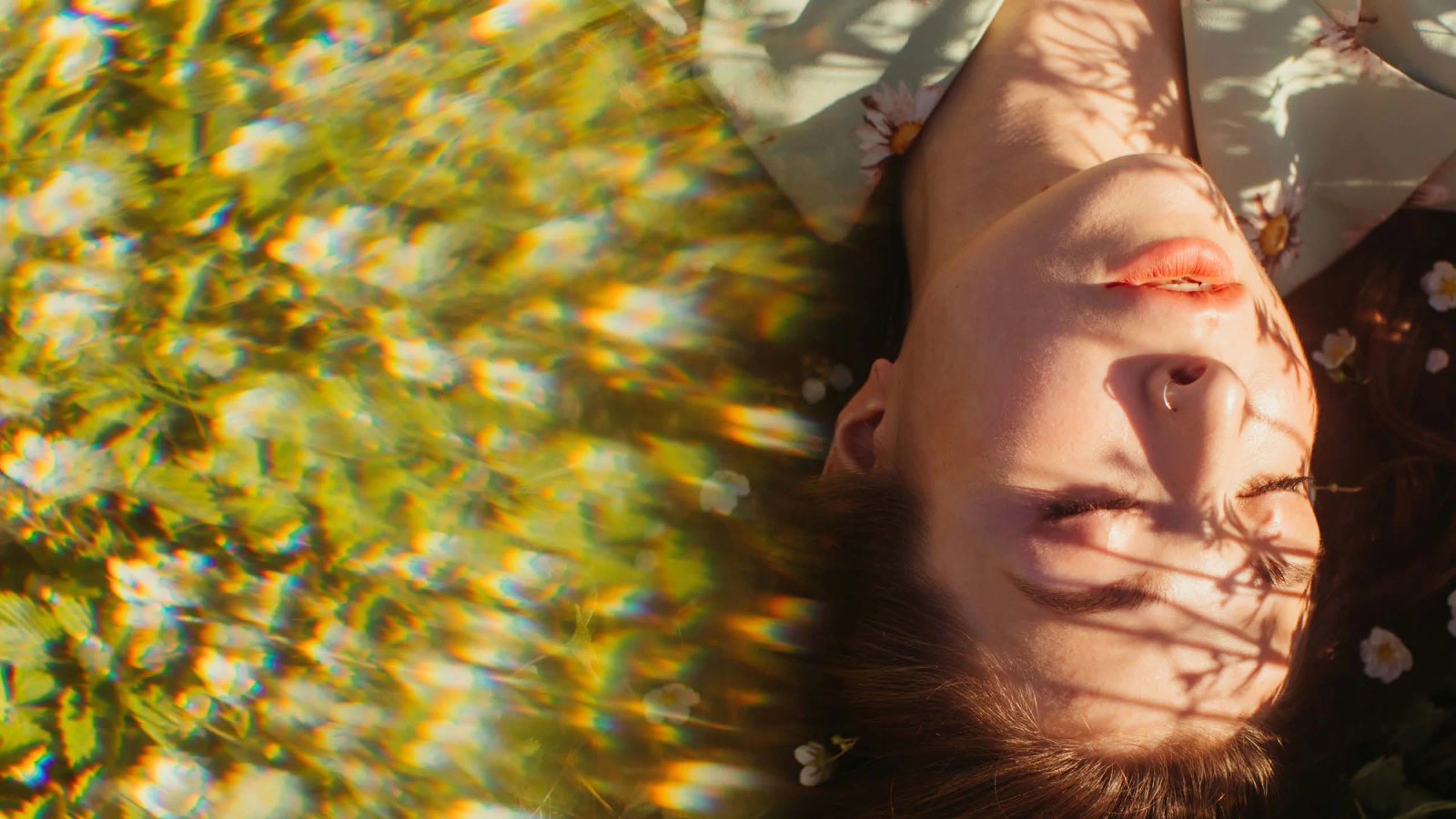 Consumer Trends 2025 cover: a person lying face up in a field of yellow flowers, with sunlight on their face.