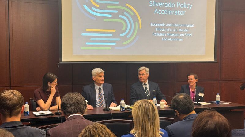 Senators Bill Cassidy and Sheldon Whitehouse and Maureen Hinman sit in front of a slide that reads Silverado Policy Accelerator, Economic and Environmental Impacts of a U.S. Border Pollution Measure on Steel and Aluminum