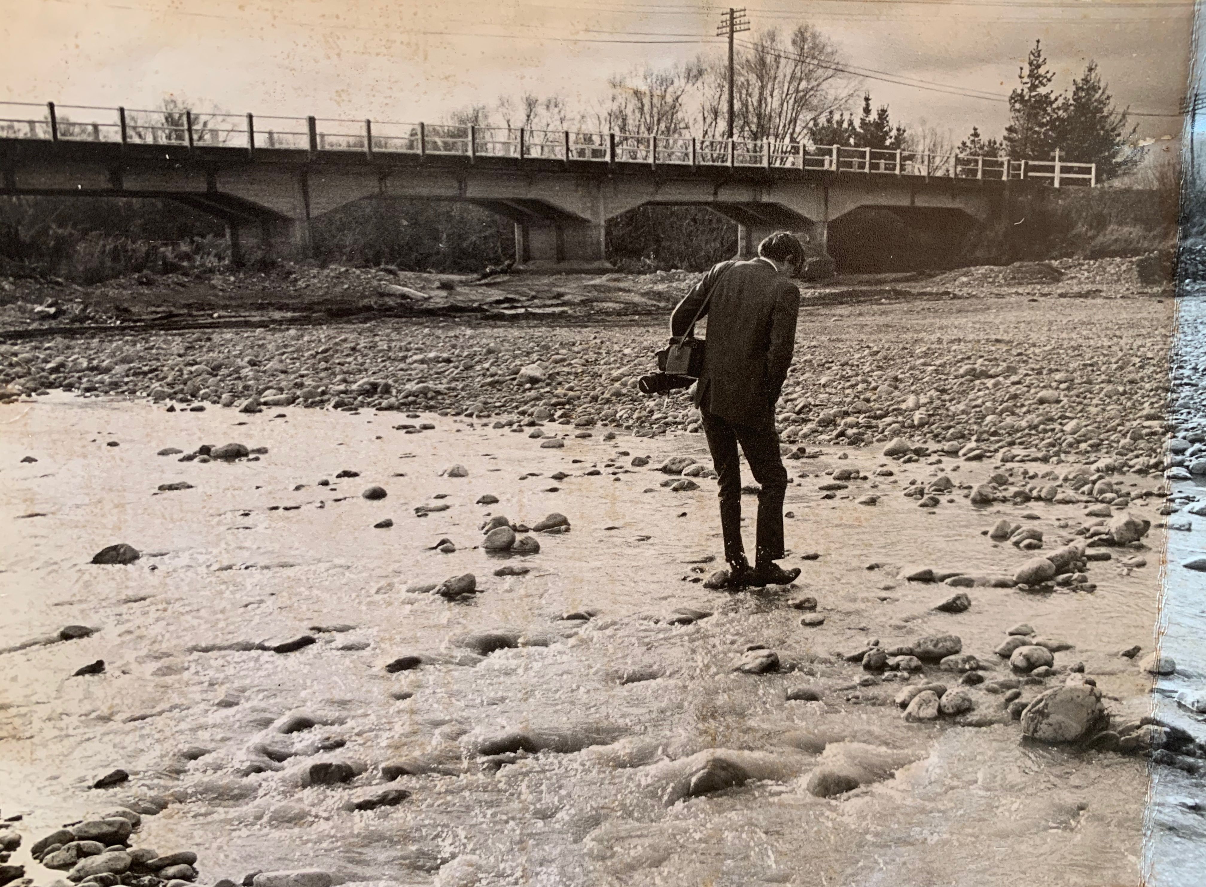 Man in a suit in a river bed