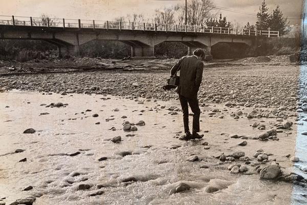Man in a suit in a river bed