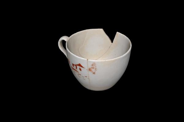 A white cup on a black background