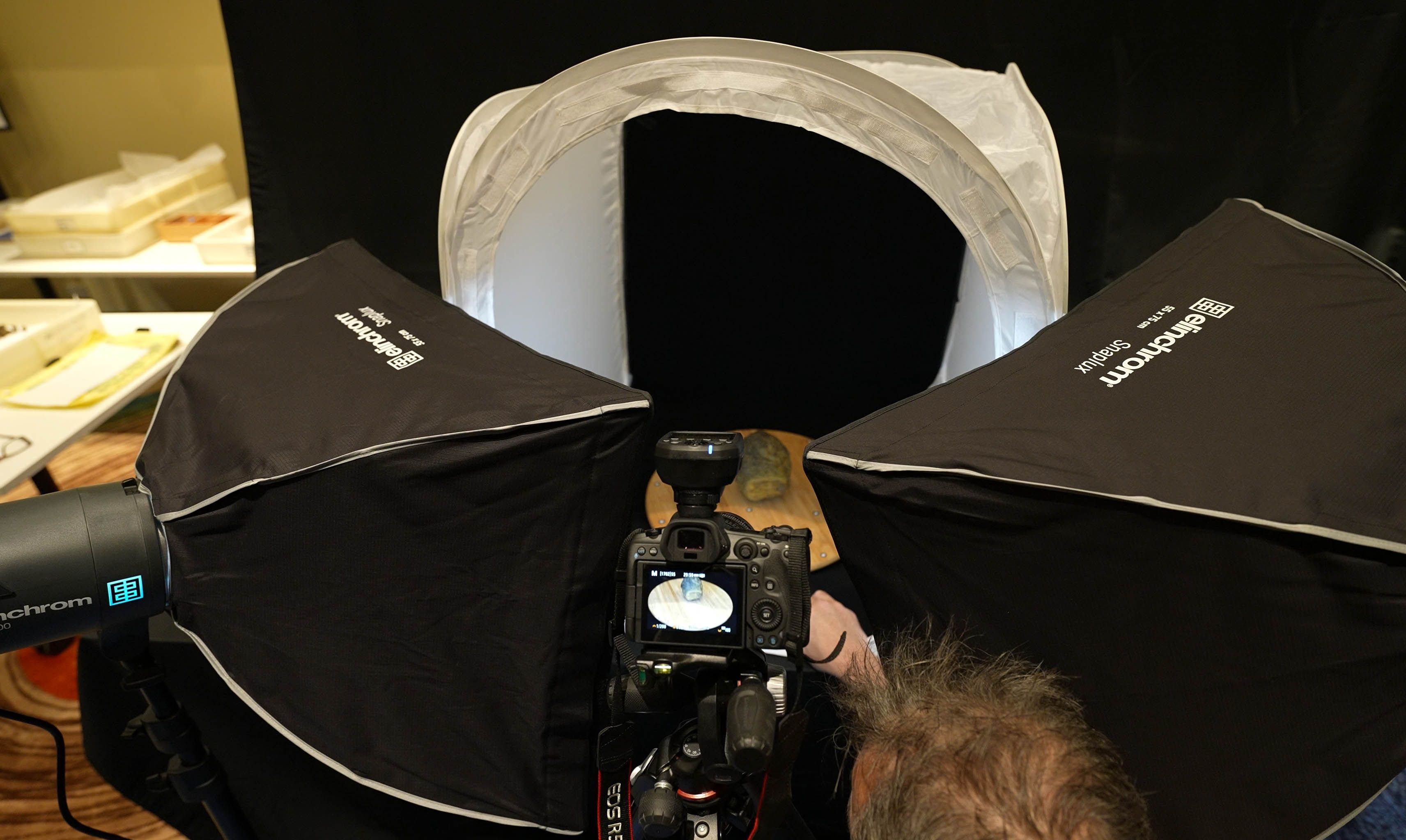 An image shoing a camera and lights with a cannonball in the centre