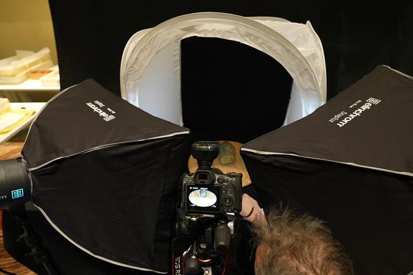 An image shoing a camera and lights with a cannonball in the centre