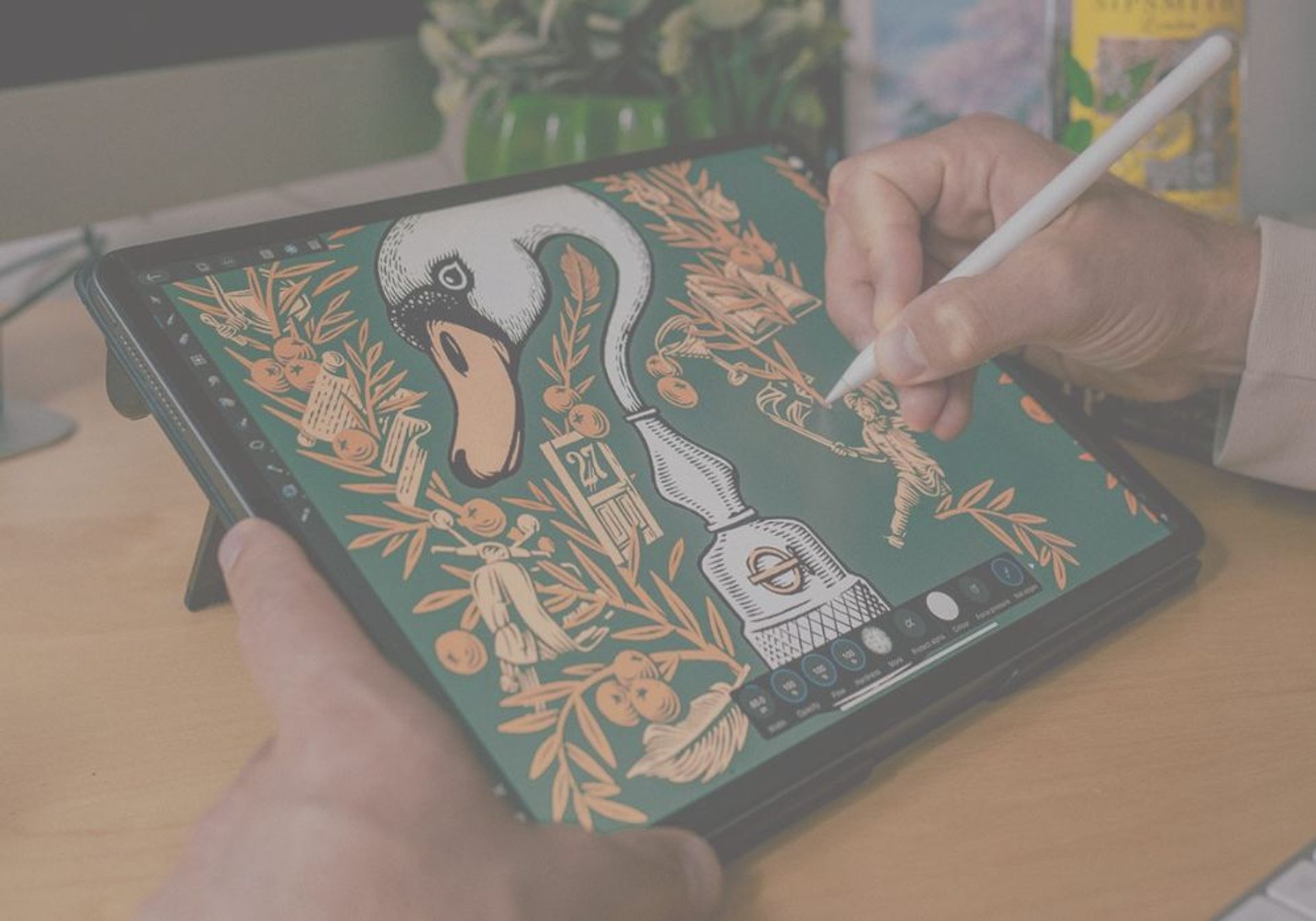 Tobias Hall uses a stylus on a tablet displaying a detailed digital illustration of a swan, an inkwell, and ornate patterns on a dark green background.