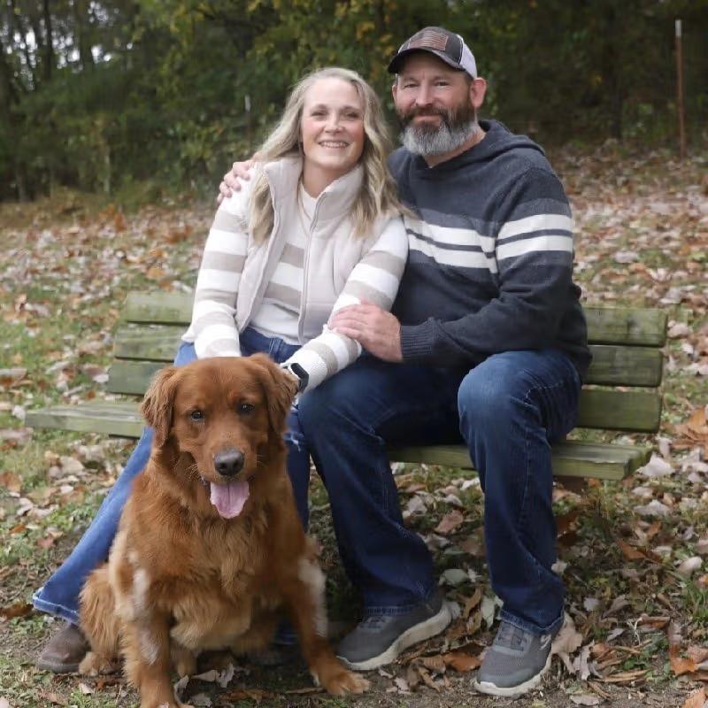 Jen Lamont and partner sitting on a bench.