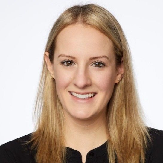 Headshot of a smiling woman with long blonde hair.