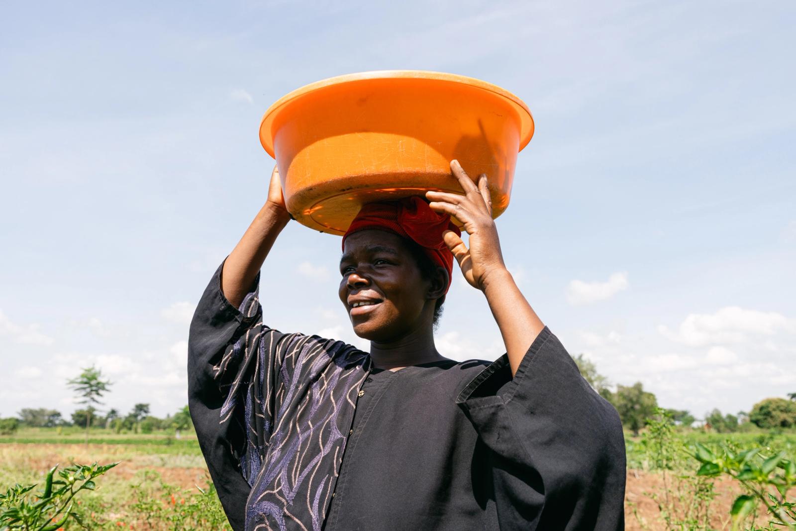 A farmer carrying a bowl on her head