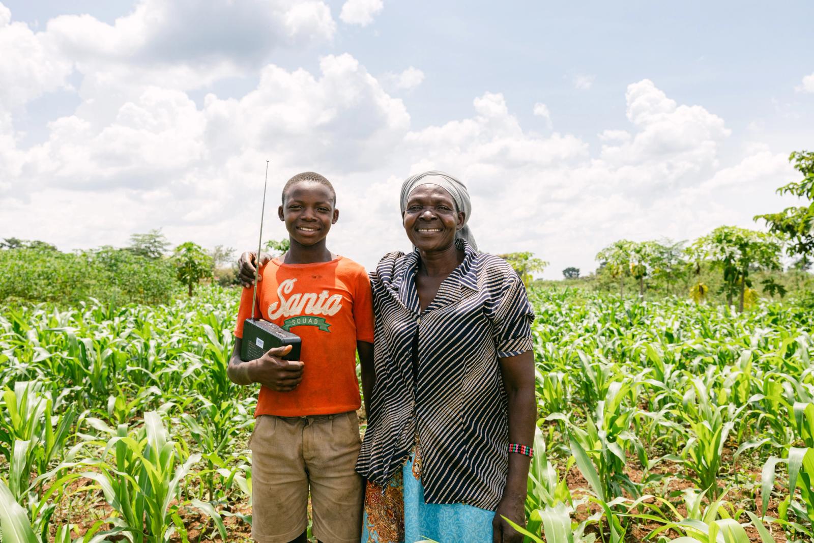 A mother and son smiling together in their field