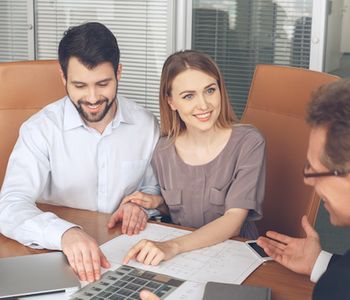 Couple talking to VA loan specialist.